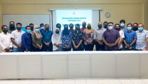 Participants in the Integrated Human Rights Program stand for a photo after a presentation